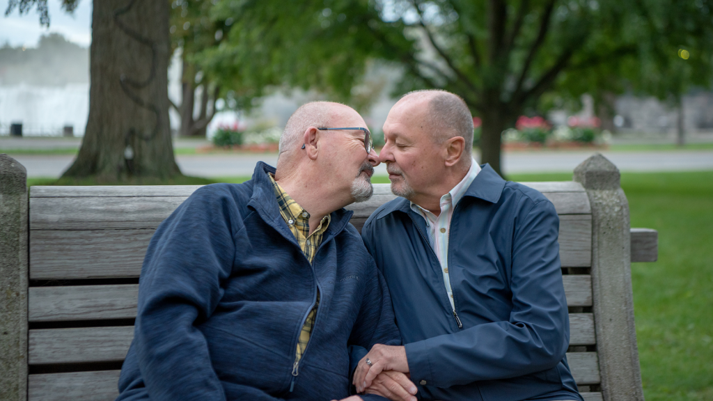 An older couple leans in for a kiss