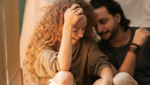 A couple with their heads together talking about sex