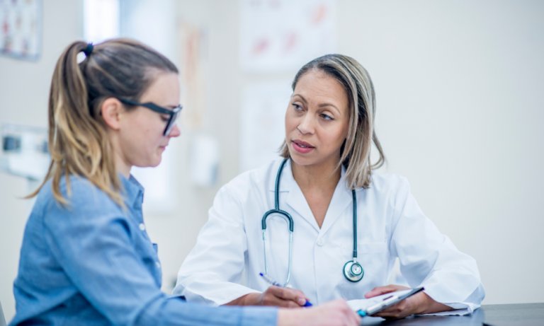 A health care provider talks to a patient