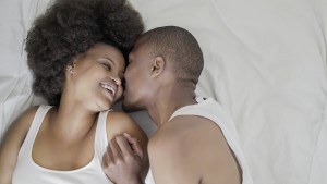 A couple in bed smiling