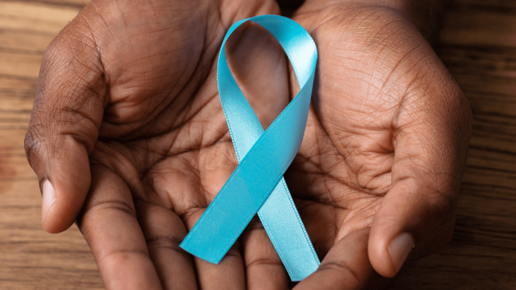 Hands holding a teal ribbon