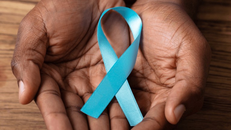 Hands holding a teal ribbon