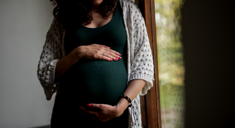 A pregnant woman holding her belly