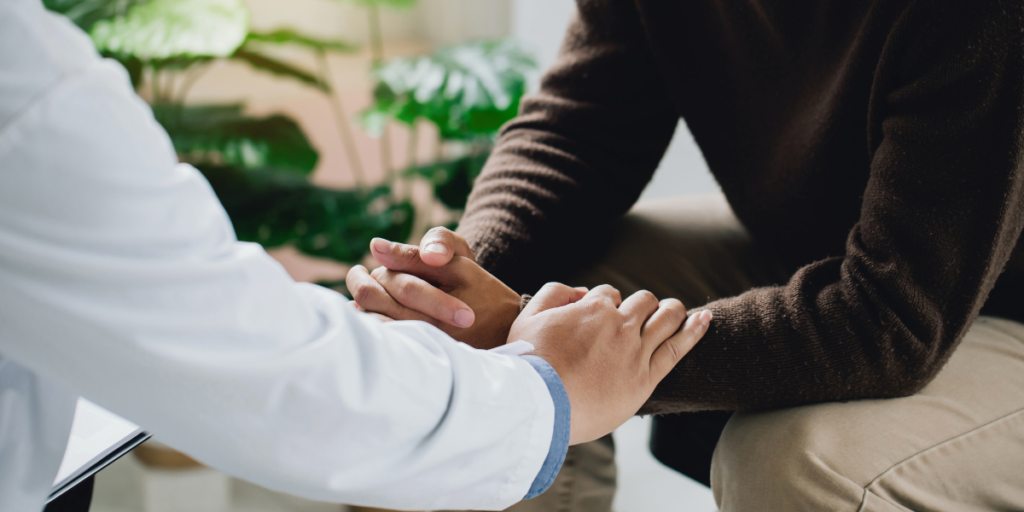 A doctor comforts a patient with HPV-related cancer