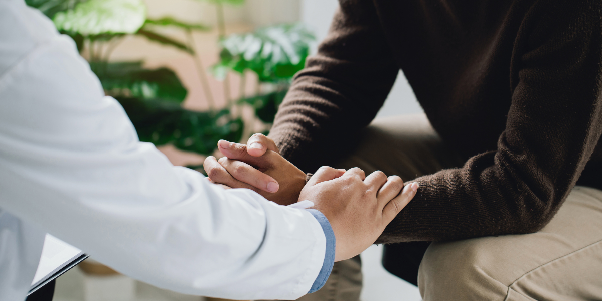 A doctor comforts a patient with HPV-related cancer