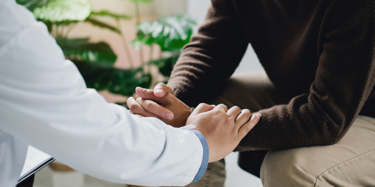 A doctor comforts a patient with HPV-related cancer