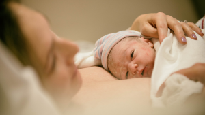 A newborn is on their mother's chest