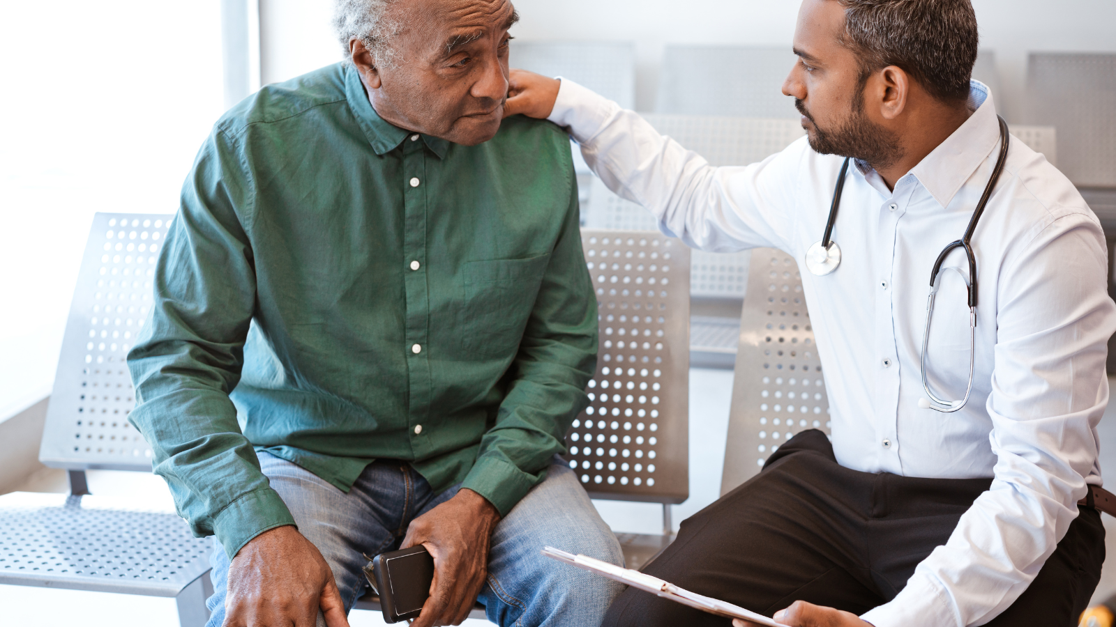 A doctor consoles a patient