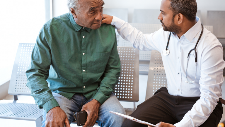 A doctor consoles a patient