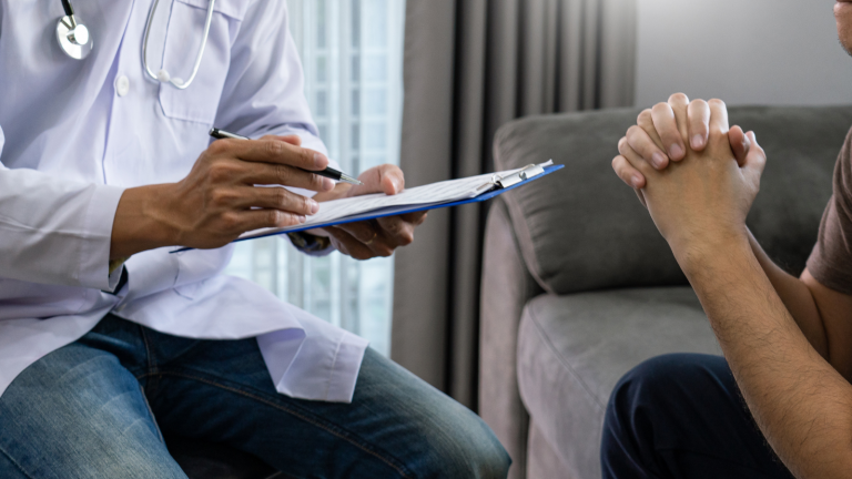 A doctor talks to a male patient