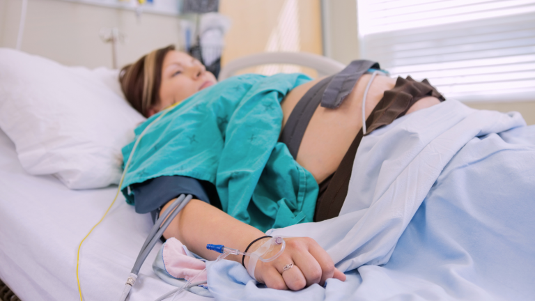Pregnant woman lies in hospital bed after epidural