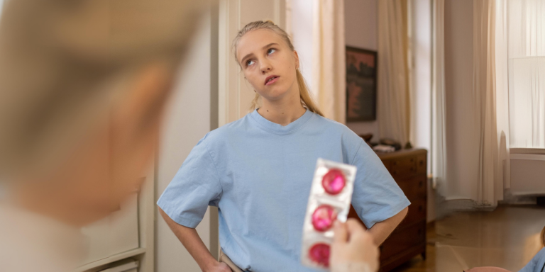 A teen is offered condoms and rolls their eyes
