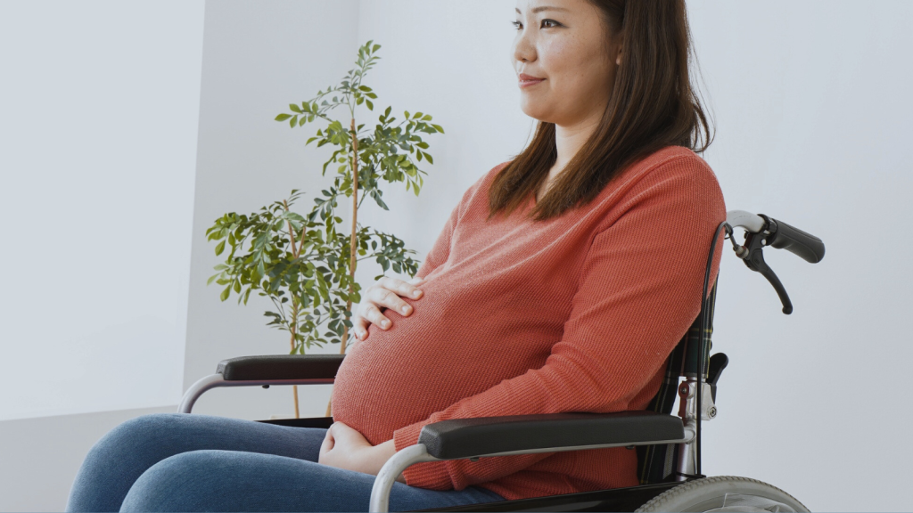 A pregnant woman in a wheelchair