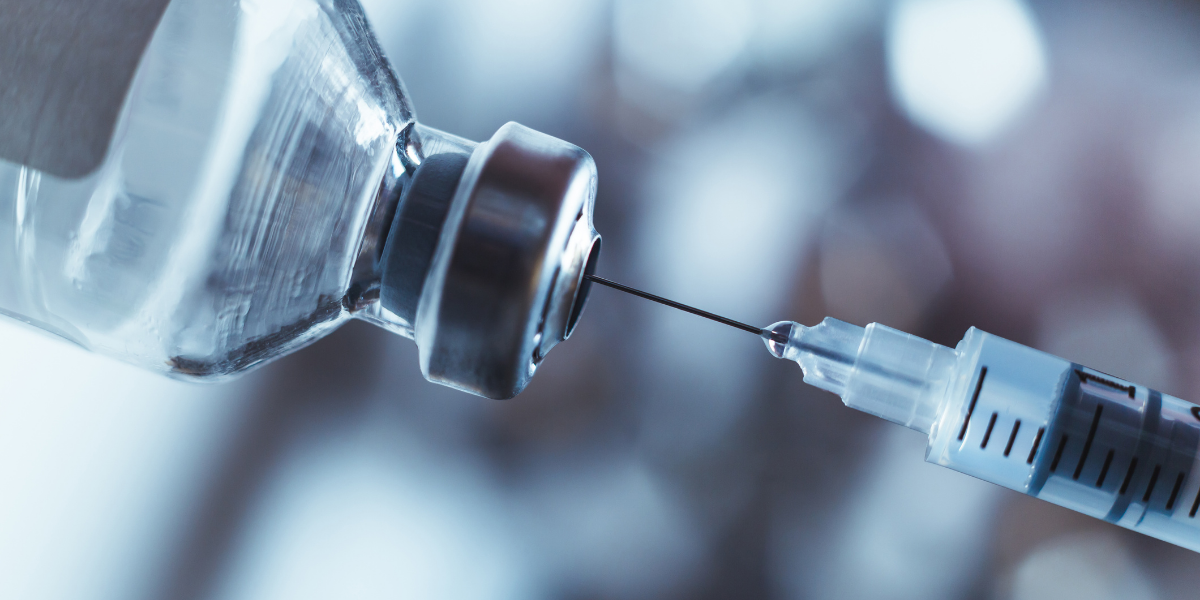 A needle is inserted into a vial