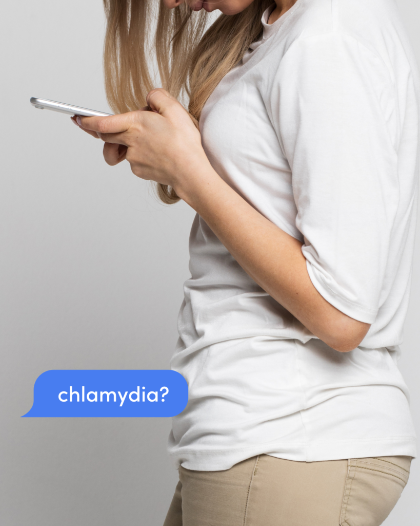 A young woman texts about chlamydia