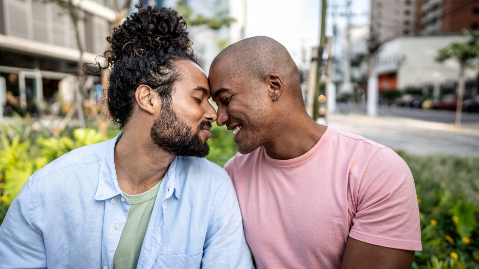 A couple sits with their foreheads together